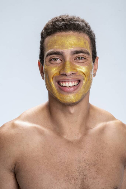 Cheerful man taking care of his face - Fotoğraf, Görsel