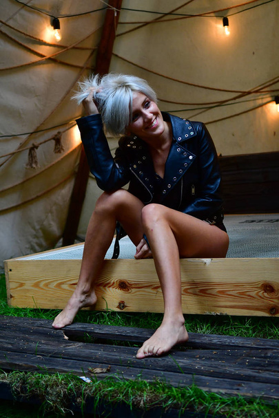 sexy blonde alone in tent with garlands of romance and leather j - Photo, Image