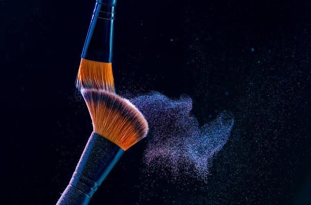Make up brush with  powder explosion on black background - Foto, immagini