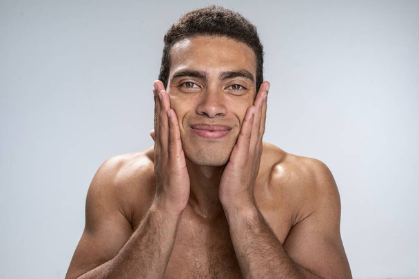 Man being satisfied with softness of his skin - Foto, afbeelding