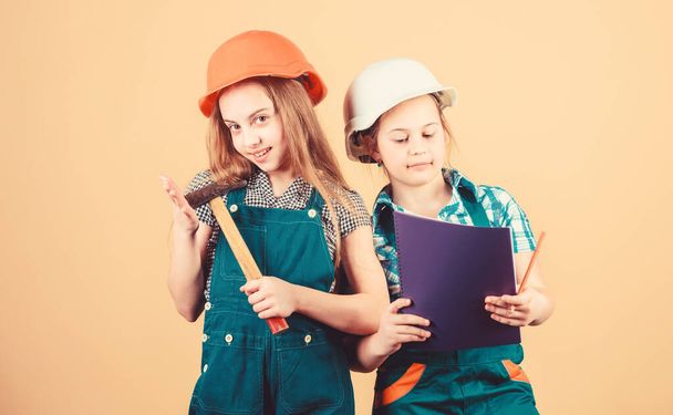 Kids happy renovating home. Home improvement activity. Kids girls with tools planning renovation. Family remodeling house. Children sisters renovation their room. Control renovation process - Фото, зображення