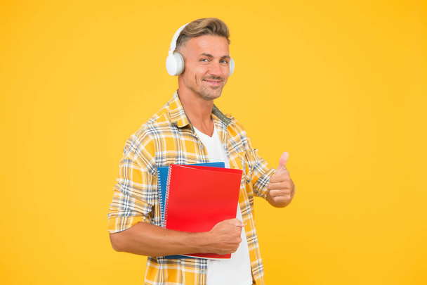 Another way of study. Learning english. Educational technology. Study. Audio book concept. Worldwide knowledge access. Audio library. Man handsome college student headphones books. Study languages - 写真・画像
