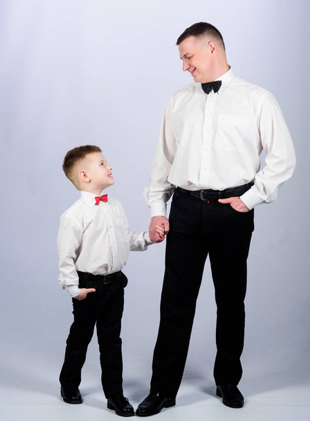 Gentleman upbringing. Visit theatre dress code. Father and son formal clothes outfit. Formal event. Grow up gentleman. Gentleman upbringing. Little son following fathers example of noble man - Foto, afbeelding