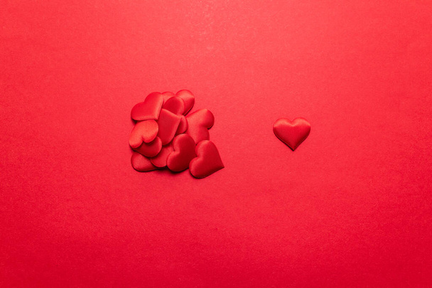Valentines day concept. Red hearts on a red background. Flat lay, top view - 写真・画像