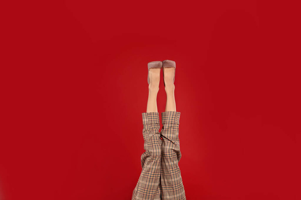 Woman in elegant shoes on red background - Fotografie, Obrázek
