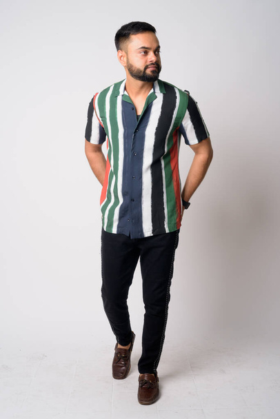 Full body shot of young bearded Indian man thinking - Foto, immagini