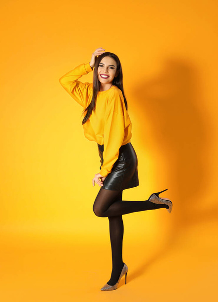 Beautiful young woman posing on yellow background. Halloween party - Φωτογραφία, εικόνα