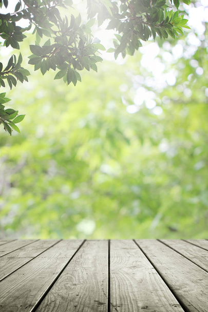 Wooden desk and blurred green nature in garden background.  - Zdjęcie, obraz