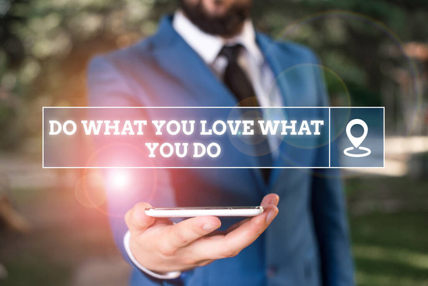 Handwriting text writing Do What You Love What You Do. Concept meaning Make things that motivate yourself Passion Businessman in blue suite stands with mobile phone in hands. - Photo, Image