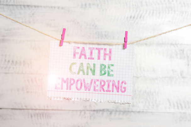 Writing note showing Faith Can Be Empowering. Business photo showcasing Trust and Believing in ourselves that we can do it Clothesline clothespin rectangle shaped paper reminder white wood desk. - 写真・画像