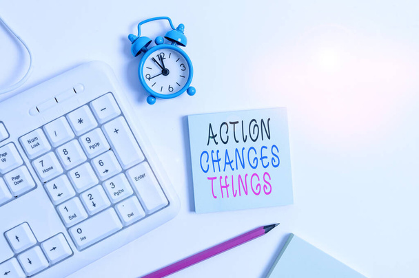 Conceptual hand writing showing Action Changes Things. Business photo showcasing doing something will reflect other things Reaction Keyboard with empty note paper and pencil white background. - Photo, Image
