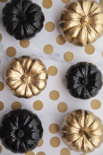 Luxury gold and black autumn pumpkin flat lay composition on a marble background - Photo, Image