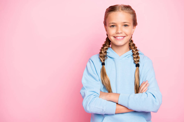Photo of cheerful positive confident girl of good mood standing confidently with arms crossed showing her intelligence near empty space isolated over pink pastel color background - Valokuva, kuva