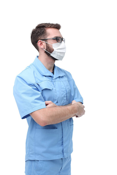 confident male doctor in surgical mask. isolated on white - 写真・画像