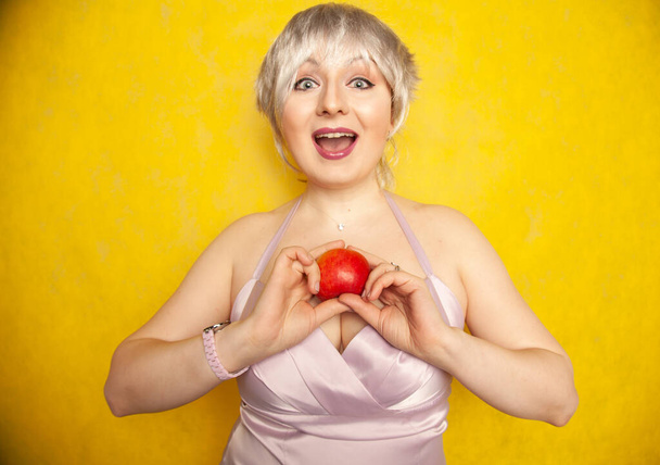 Κοντινό πλάνο όμορφη νεαρή γυναίκα κρατώντας ένα μήλο shes έτοιμος να φάει - Φωτογραφία, εικόνα