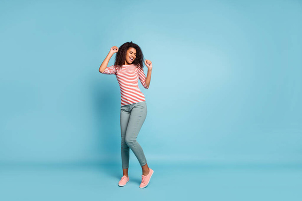 Full size photo of funny dark skin wavy lady enjoy amazing party mood funny chilling dancing wear casual clothes isolated pastel blue color background - Photo, Image