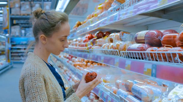 Woman buying sausage at supermarket - Photo, image