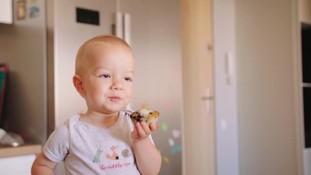 Baby Boy Eating Cupcake in the Kitchen - Кадри, відео