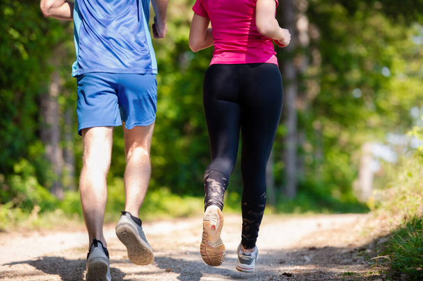 young couple jogging on sunny day at nature - Photo, Image