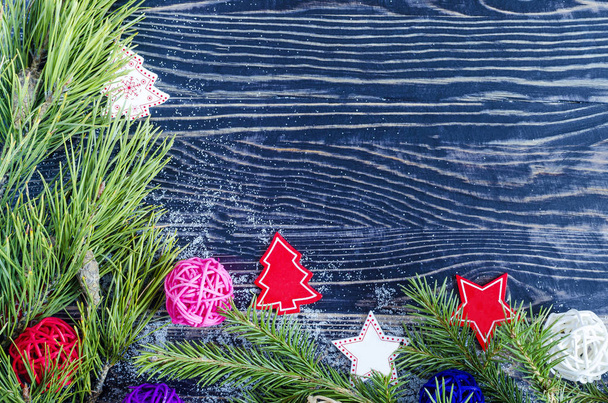 pine branch and Christmas decoration on dark background, top view - Valokuva, kuva