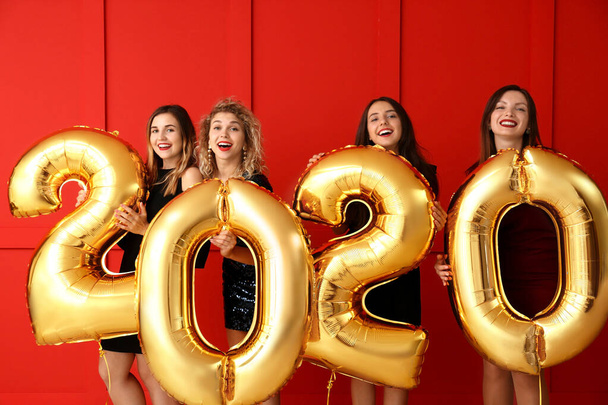 Beautiful young women with balloons at Christmas party - Photo, image