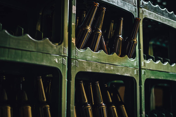 Glass beer bottles in box, craft beer brewery. - Fotó, kép