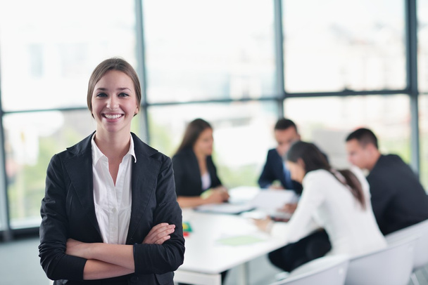 Business woman with her staff in background at office - Photo, image