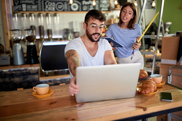 coffee store.Man working on laptop and woman together. - Φωτογραφία, εικόνα