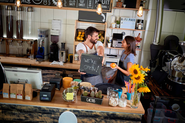 Coffee business concept.owner of a cafe showing open sign. - Foto, imagen