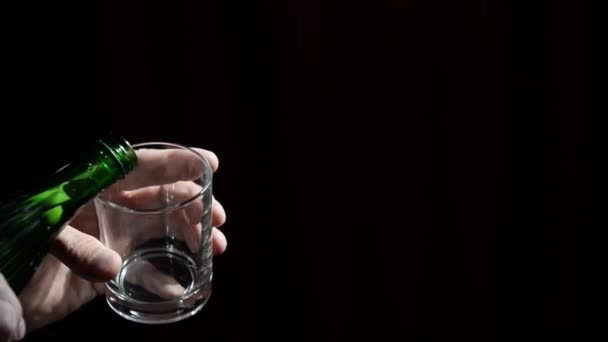 Pour clear water into a glass. Male hand hold clean glass and pour into it clean fresh water. Concept ecology - Filmmaterial, Video