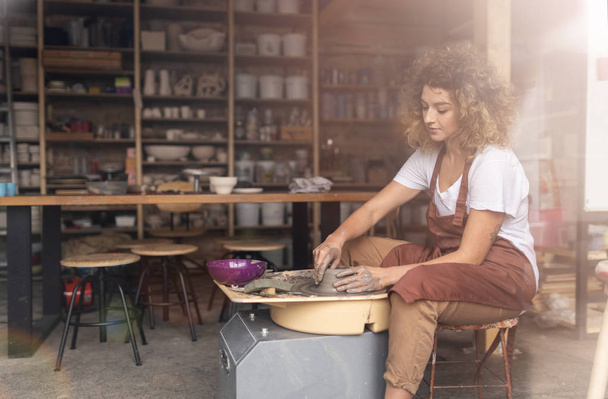 Woman making ceramic work with potter's wheel - Zdjęcie, obraz