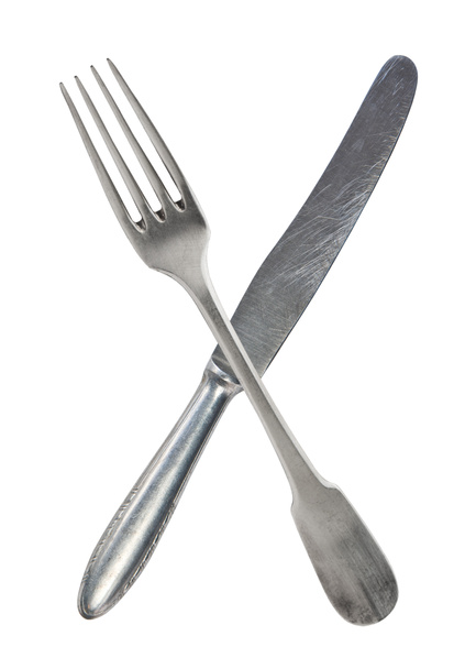 Gekruiste vintage gekruiste vork en mes geïsoleerd op bel backgrou - Foto, afbeelding