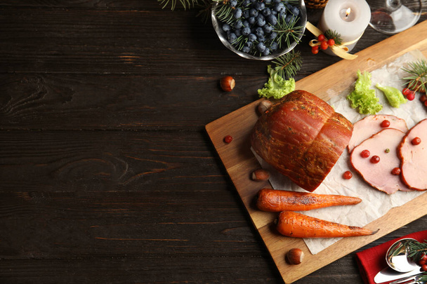Flat lay composition with delicious ham on black wooden table, space for text. Christmas dinner - Valokuva, kuva