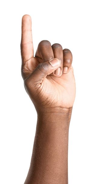 Hand of African-American man pointing at something on white background - Фото, изображение