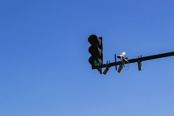 Traffic light with green color, surveillance camera and sensors - Foto, afbeelding