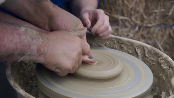 Workshop molding of clay on potter's wheel. Dirty hands in the clay. Making ceramic products. Artistic creative. Sculptor sculpts pots products from white clay. Master crock. Potter's work close-up. - Footage, Video