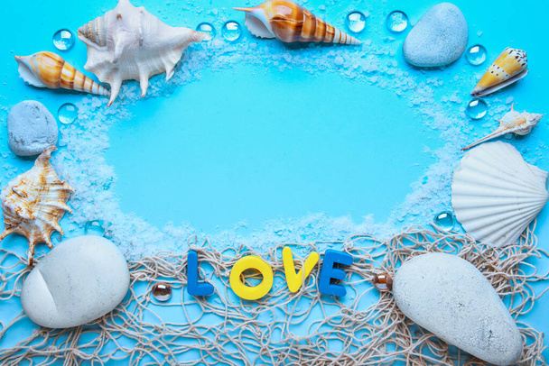 Frame made of marine decor with shells and word LOVE on color background - Φωτογραφία, εικόνα