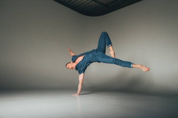shot of mad, crazy, cheerful, successful, lucky guy in casual outfit, jeans, jumping with hands up,triumphant, gesturing against white background - Zdjęcie, obraz