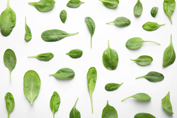 Fresh green healthy spinach leaves with water drops on white background, top view - Fotoğraf, Görsel