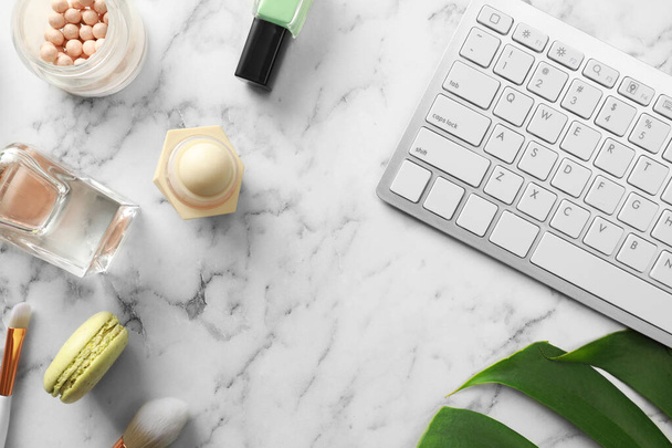 Flat lay composition with keyboard on marble table. Beauty blogger's workplace - Фото, изображение