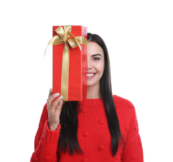 Happy young woman holding Christmas gift on white background - Fotografie, Obrázek