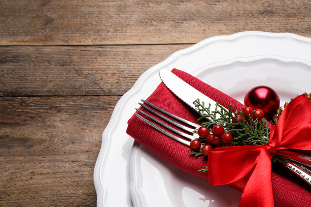 Beautiful Christmas table setting on wooden background, closeup - Фото, зображення