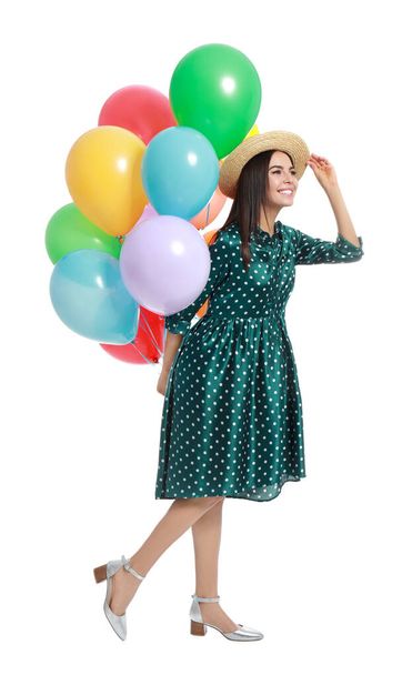 Young woman holding bunch of colorful balloons on white background - Valokuva, kuva