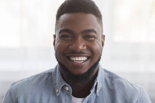 Portrait of black millennial guy with happy smile on face - Foto, imagen