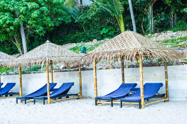 Umbrella and chair on the tropical beach sea and ocean - Φωτογραφία, εικόνα