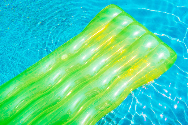 Colorful swim ring or rubber float around swimming pool water - Photo, Image