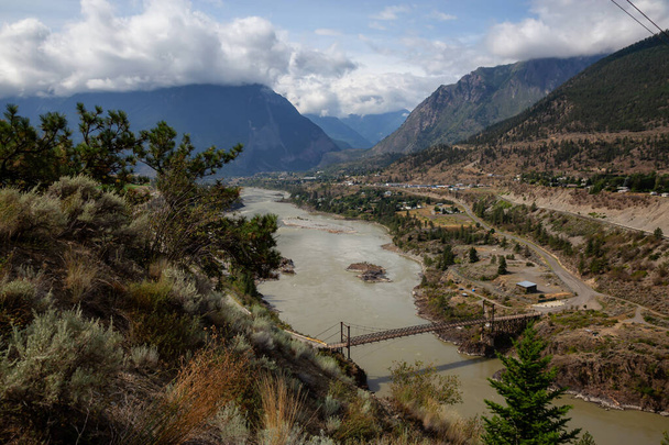 Beautiful View of a small Town, Lillooet, during a sunny and cloudy summer day. Located in the Interior British Columbia, Canada. - Фото, зображення