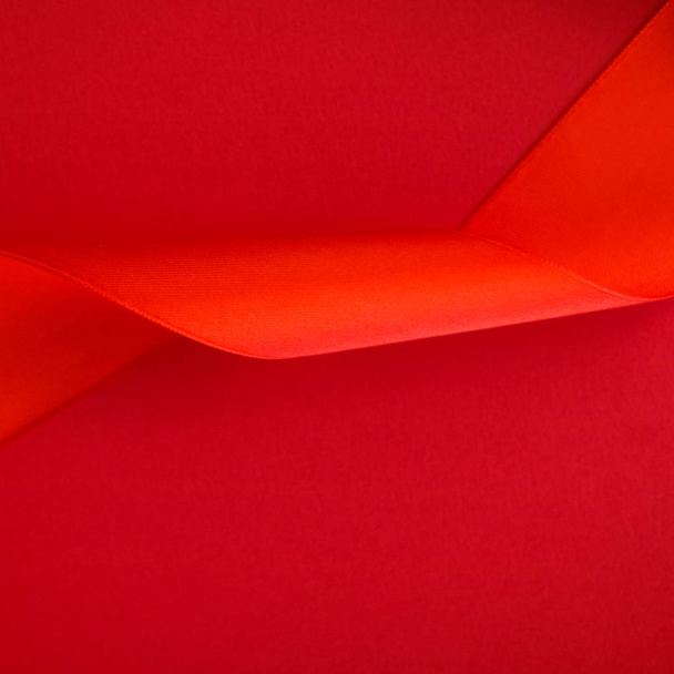 Abstract curly silk ribbon on red background, exclusive luxury b - Φωτογραφία, εικόνα