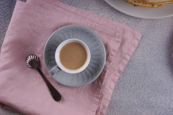 ピンクのナプキンにミルクとコーヒーの小さなカップ - 写真・画像