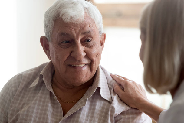 Close up view focus on elderly patient communicates with nurse - Photo, Image